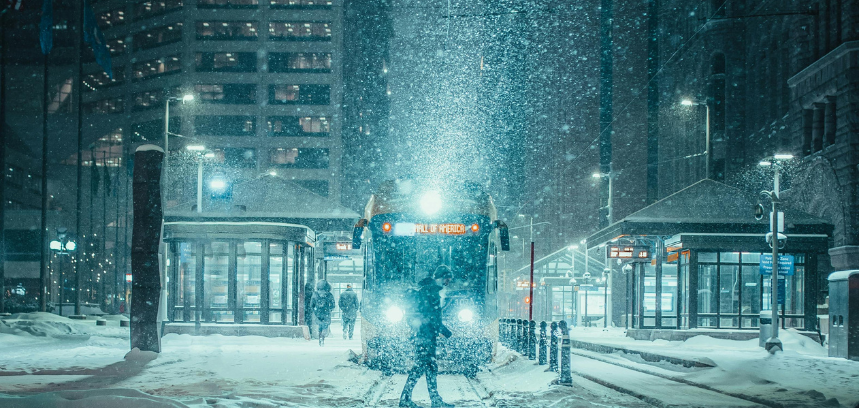 Bus in city during snowstorm